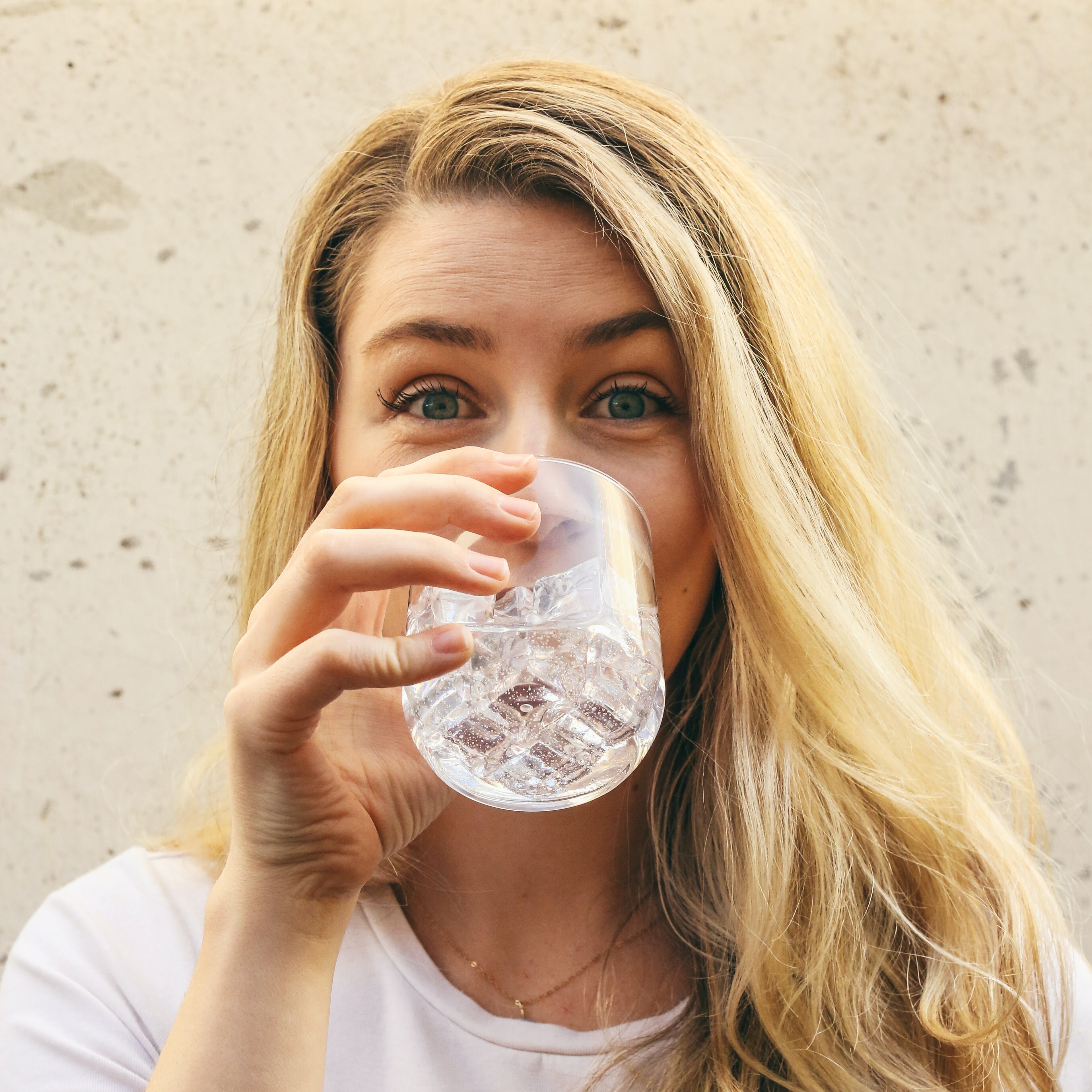 Healthy woman drinking a glass of water