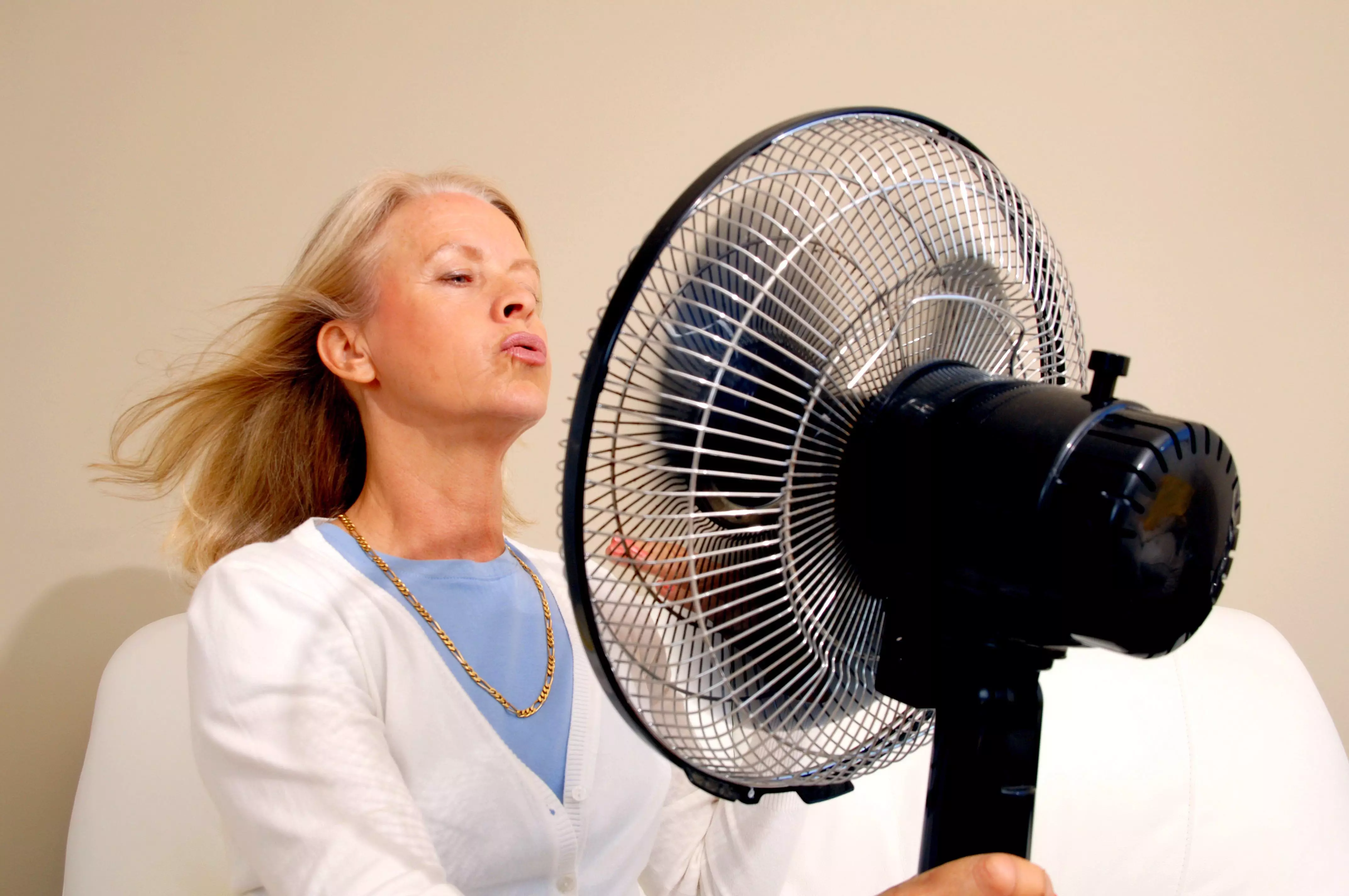 Menopausal woman in front of a fan