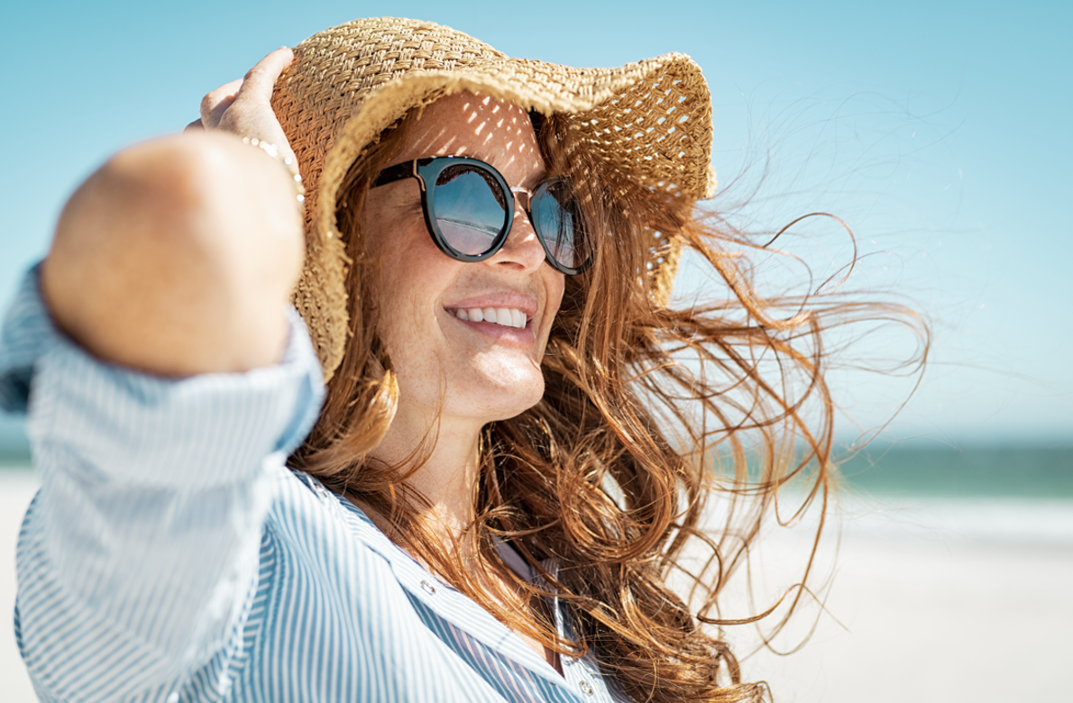 woman enjoying the summer sun on a beach